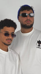 Two men wearing sunglasses and white shirts with a logo on a plain background