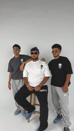 Three men posing together on a white background