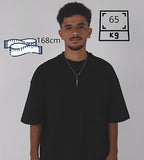 Man wearing a black t-shirt with height and weight measurements displayed on a gray background